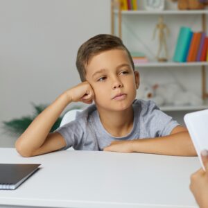 Child sitting in a calming space with a counselor, expressing emotions through art, highlighting compassionate and supportive counseling services.